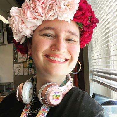 A photo of a feminine person with a flower crown